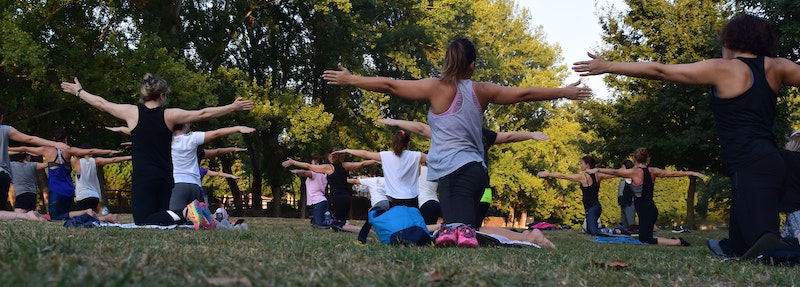 yoga class practicing outside with an instructor